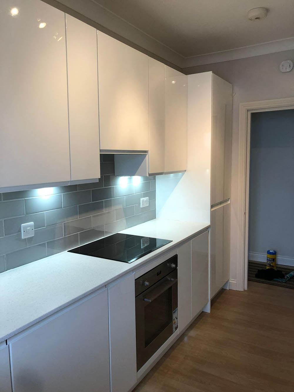 Modern white kitchen with grey tile backsplash